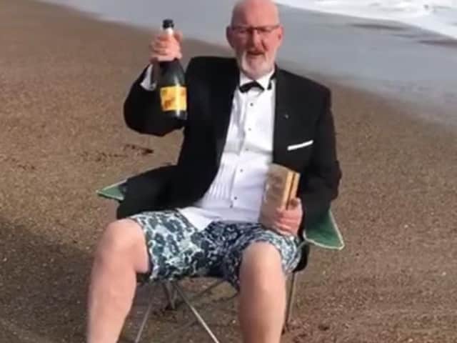 Steve Andrews, manager of the Hildreds Centre in Skegness, on the beach celebrating winning the retail industry's 'Oscar' - the Purple Apple award.