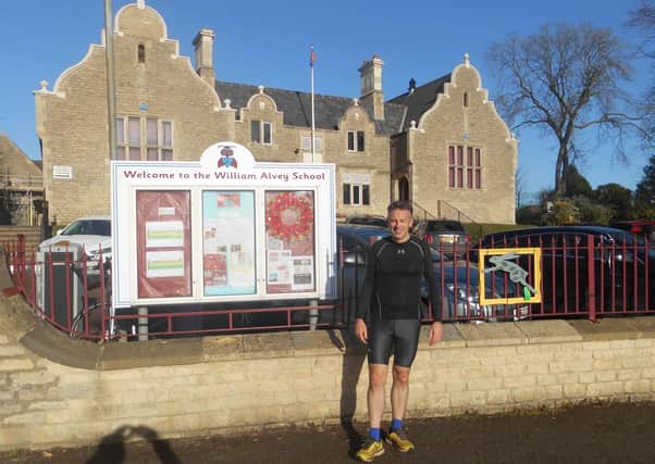 On a mission. Vicar of Sleaford Fr Philip Johnson in his running gear outside Wiliam Alvey School. EMN-201120-150525001