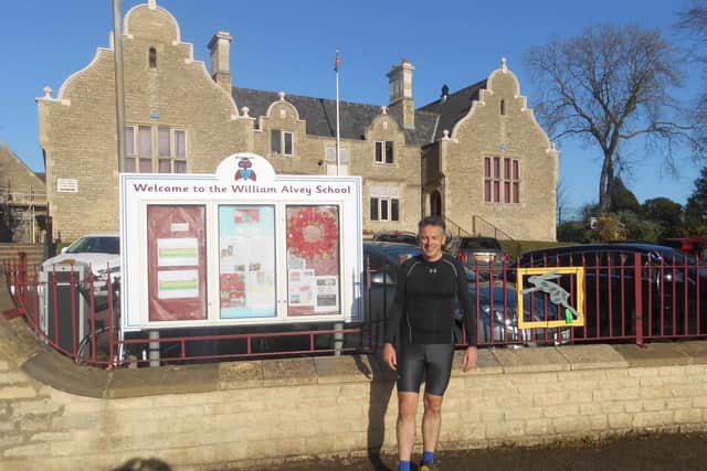 On a mission. Vicar of Sleaford Fr Philip Johnson in his running gear outside Wiliam Alvey School. EMN-201120-150525001