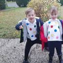 Reuben and Florence, pictured taking their sponsorship money to their school.