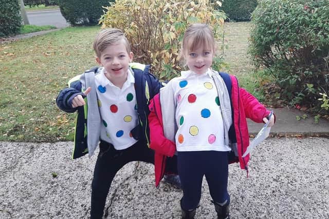 Reuben and Florence, pictured taking their sponsorship money to their school.