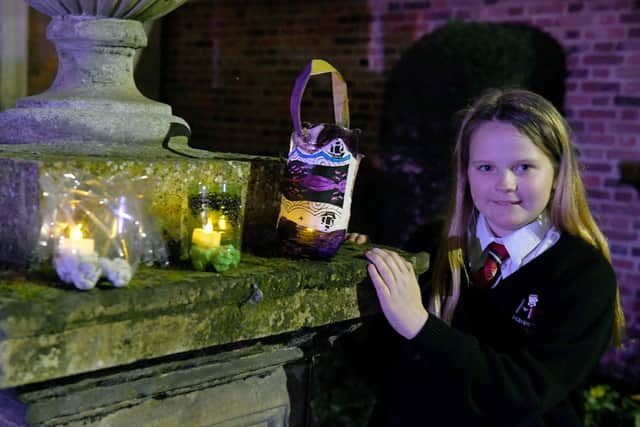 Illuminated lantern festival in Boston, celebrating 400th anniversary of the Pilgrim story. Lily-Star Dainty-Morrison 11 with lanterns at Fydell House. EMN-201127-130510005