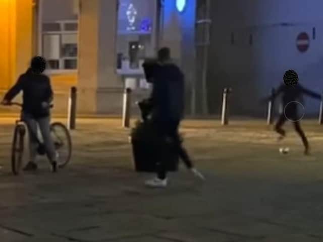 A youth kicks a bauble on the video. We have chosen to obscure out the visible faces
