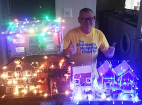 Patrick Carlin, pictured with some of his themed wooden houses.