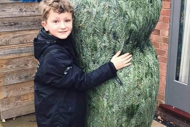 Victoria and Nigel Hopper's son, Rupert (10), with the original Christmas tree. (Photo: The Brown Cow)
