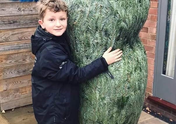 Victoria and Nigel Hopper's son, Rupert (10), with the original Christmas tree. (Photo: The Brown Cow)