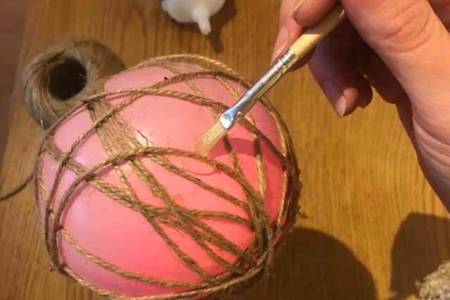 You can make a rustic Christmas ornament out of decorative twine.