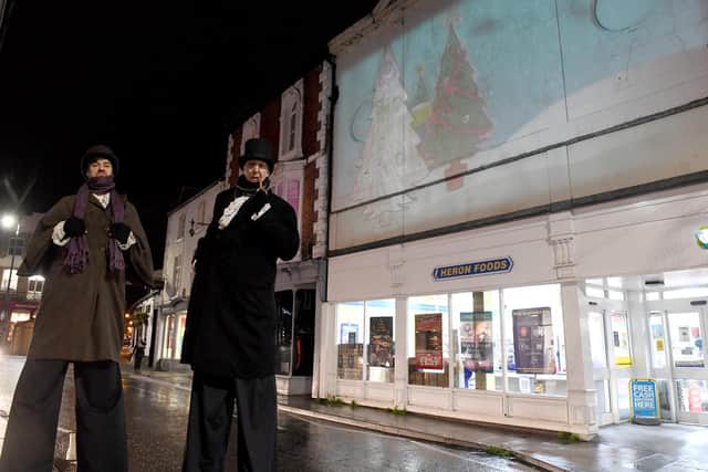 Stiltwalkers Neil Hutson and Mark Atkinson of Earthbound Misfits entertaining visitors to the Hope and Light festival in Louth during late night shopping.