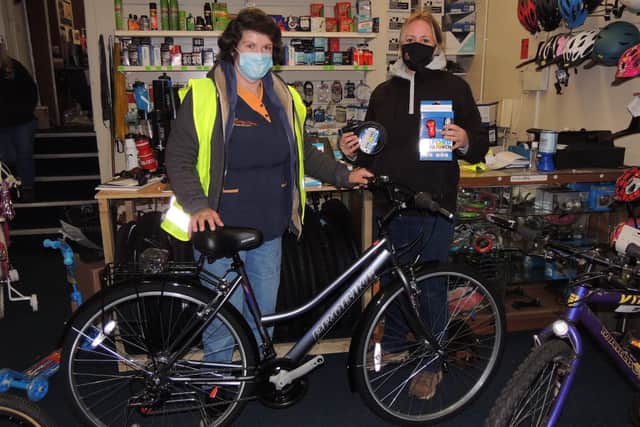 Janet Brummit, left, with sister Sally Hughes and the new bike she has picked out thanks to locals Christmas spirit. EMN-200712-143054001