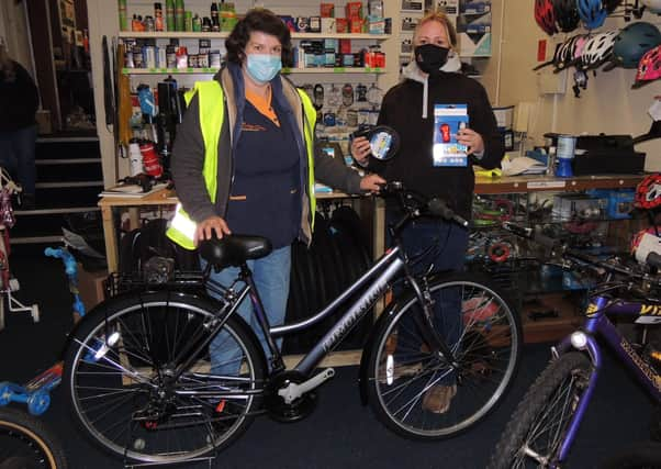 Janet Brummit, left, with sister Sally Hughes and the new bike she has picked out thanks to locals Christmas spirit. EMN-200712-143054001