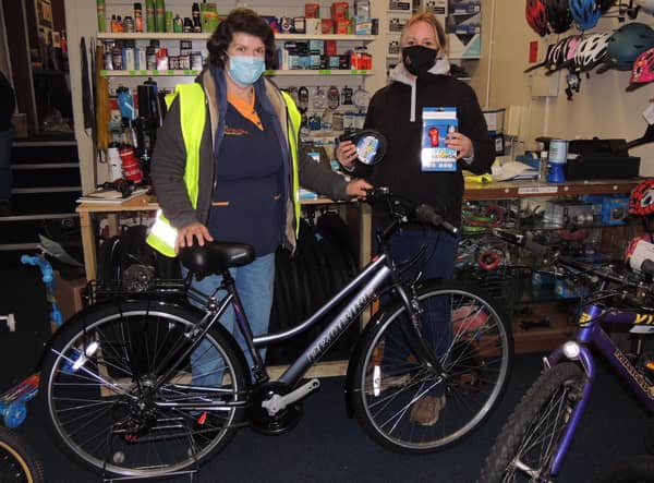 Janet Brummit, left, with sister Sally Hughes and the new bike she has picked out thanks to locals Christmas spirit. EMN-200712-143054001