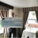 David Smith, owner of Bacchus Hotel, with the cheque