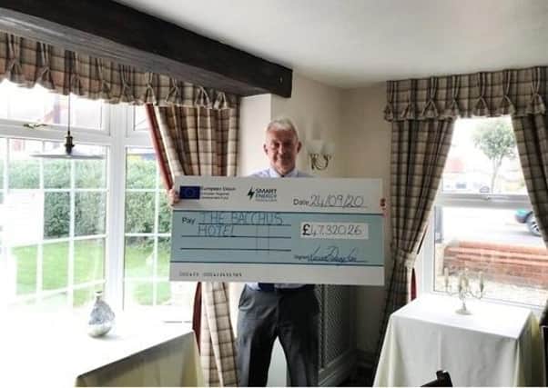 David Smith, owner of Bacchus Hotel, with the cheque
