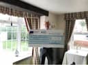 David Smith, owner of Bacchus Hotel, with the cheque