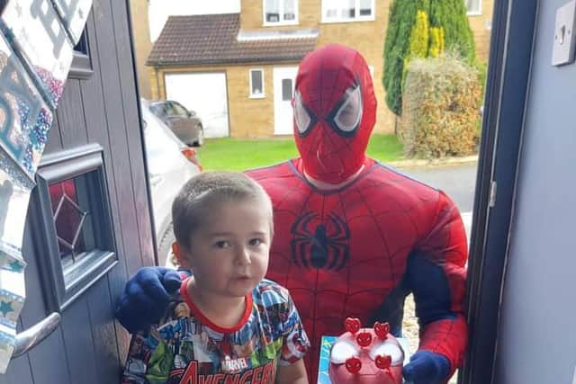 Oscar Wainwright with the gift and birthday cake he received from Spider Man.