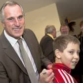 Ray Clemence signs the top of Connor Wall, 10.