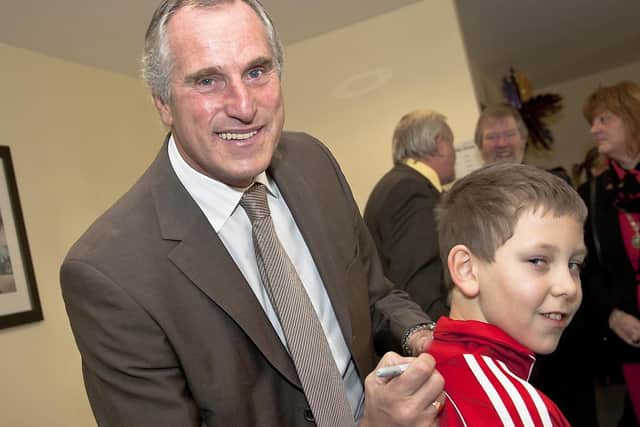 Ray Clemence signs the top of Connor Wall, 10.