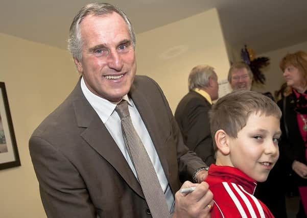 Ray Clemence signs the top of Connor Wall, 10.