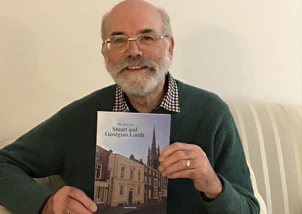 Dr Richard Gurnham with a copy of his brand new book