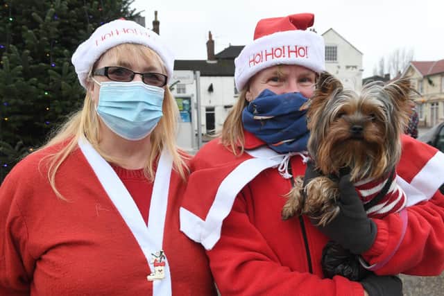 Mandy Toyne, Susan Wilson and her dog Delilah dressed as Santa for the funeral procession.