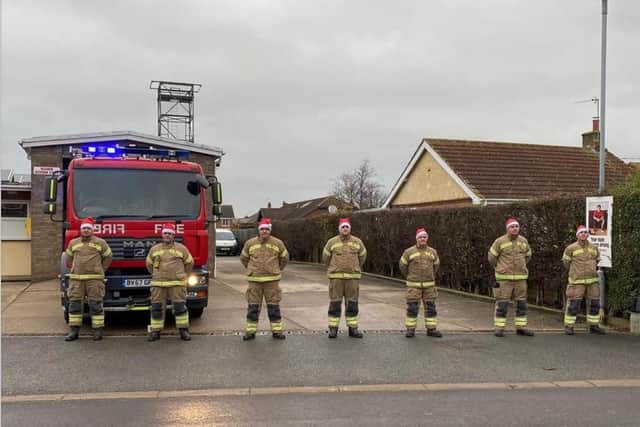 Wainfleet Fire Brigade stood by the engine which used to pull Santa's sleigh through the town.