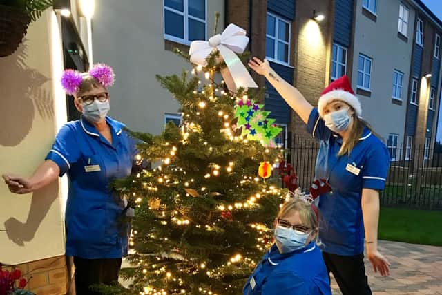 Pictured (from left) Mandy Eldred, Julie Bee (in front of tree), and Charlotte Pollard.