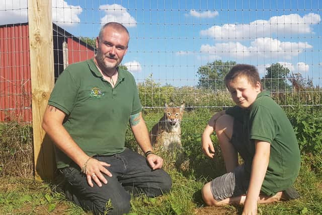 Jamie Mintram, co-director of the Ark Wildlife Park, with son Josh and Echo the lynx.