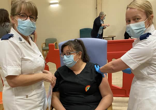 Ashdene care home manager Jilly Hunt gets her vaccine jab from nursing staff at Lincoln. EMN-201214-192040001