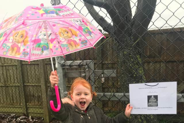 Caythorpe primary school pupil Isla Armitage, 5, finds the final clue of the Christmas treasure hunt at the school's back gate.