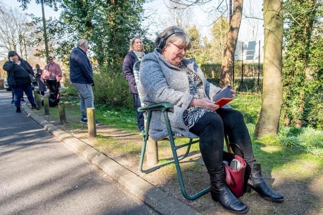 The waiting game - this photo of queues at the pharmacy was taken in the summer when it least the sun was shining