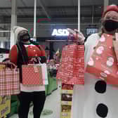 Asda colleagues Jess Young (L) and Jane Alder (R) helping to spread Christmas joy to the local community.