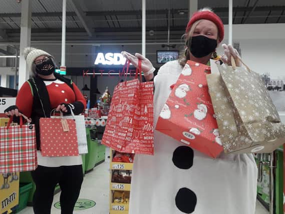 Asda colleagues Jess Young (L) and Jane Alder (R) helping to spread Christmas joy to the local community.