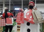 Asda colleagues Jess Young (L) and Jane Alder (R) helping to spread Christmas joy to the local community.