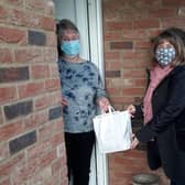 Pamela Lambe receives her Christmas surprise from Age UK Lindsey Befriending Administration Assistant Kathryn Pollard.