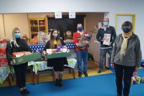 Marketing co-ordinators for Cema Lighting Chloe Land and Bella Slade with New Life Church food bank co-ordinator Rhona Sheppard and volunteers Stuart and James