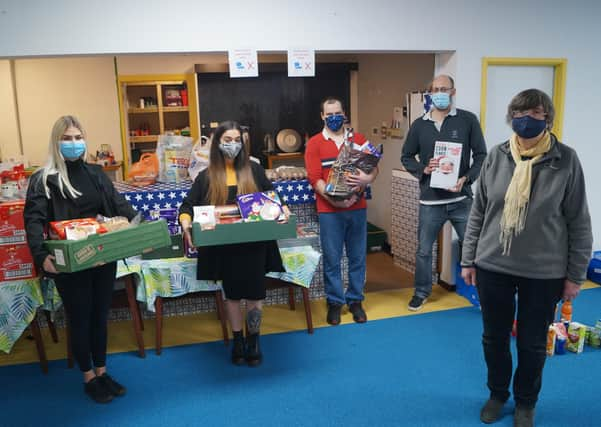 Marketing co-ordinators for Cema Lighting Chloe Land and Bella Slade with New Life Church food bank co-ordinator Rhona Sheppard and volunteers Stuart and James