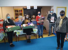 Marketing co-ordinators for Cema Lighting Chloe Land and Bella Slade with New Life Church food bank co-ordinator Rhona Sheppard and volunteers Stuart and James