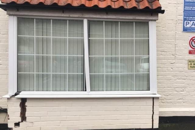 The badley damaged bay window of Dr Caroline Johnson's office in White Hart mews after a car backed into it. EMN-201221-110022001