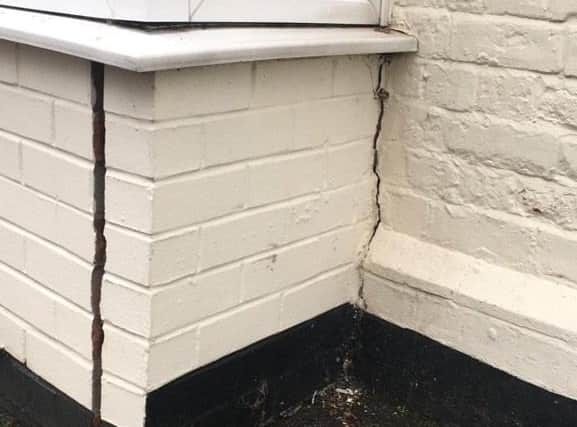 The cracked wall around the bay window of Dr Caroline Johnson's office in White Hart Mews, caused by the collision. EMN-201221-110011001