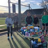 Louth Hockey Club members with some of the donations. 1aaS5jUBPOjENy5PDjY_