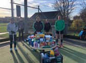 Louth Hockey Club members with some of the donations. 1aaS5jUBPOjENy5PDjY_