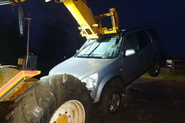The suspected hare courser's 4x4 is removed by a farmer after getting bogged down in a field and seized by police. EMN-201229-113734001