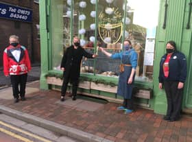 Jen Allmond, Rachel Bell and Keb Betts from Markt Rasen's Tesco store hand the trophy over to Jenny Salvidge