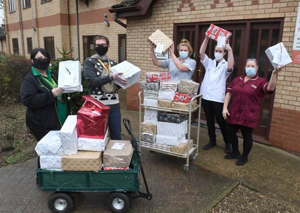 Simon Manning (deputy manager) and Helen Shaw (team leader) handing gifts over to care home staff (from left) Shanice Butterwick, James Black (care assistants), and Sharon Young (senior care assistant).