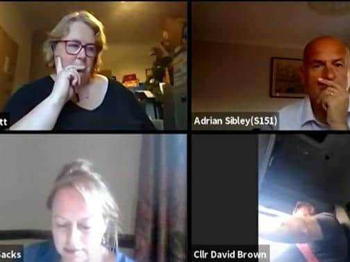 Coun Brown (bottom right) apparently driving during the meeting