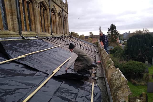 Makeshift repairs being made to the roof of St Andrew's Church, Billingborough after the lead theft. EMN-210601-184744001