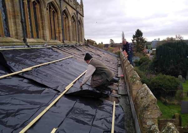 Makeshift repairs being made to the roof of St Andrew's Church, Billingborough after the lead theft. EMN-210601-184744001