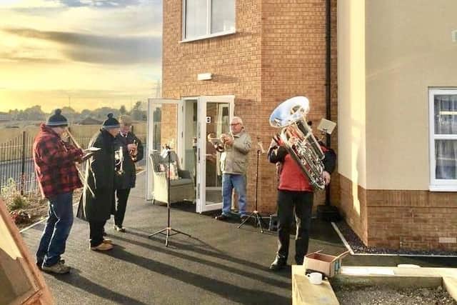 Raising spirits with an alfresco performance at Avocet House Care Home, members of Swineshead Silver Band.