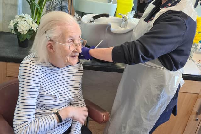 Jill Miller receiving her jab