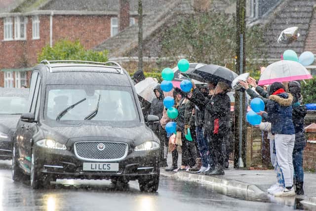 People gathered in the sleet to pay their respects